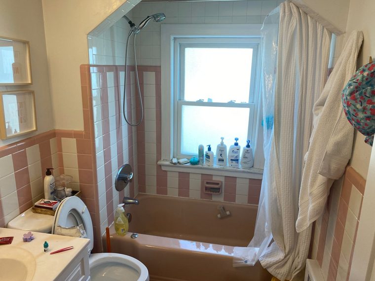 Bathroom with a dated tub, wall tile and floor before refinishing