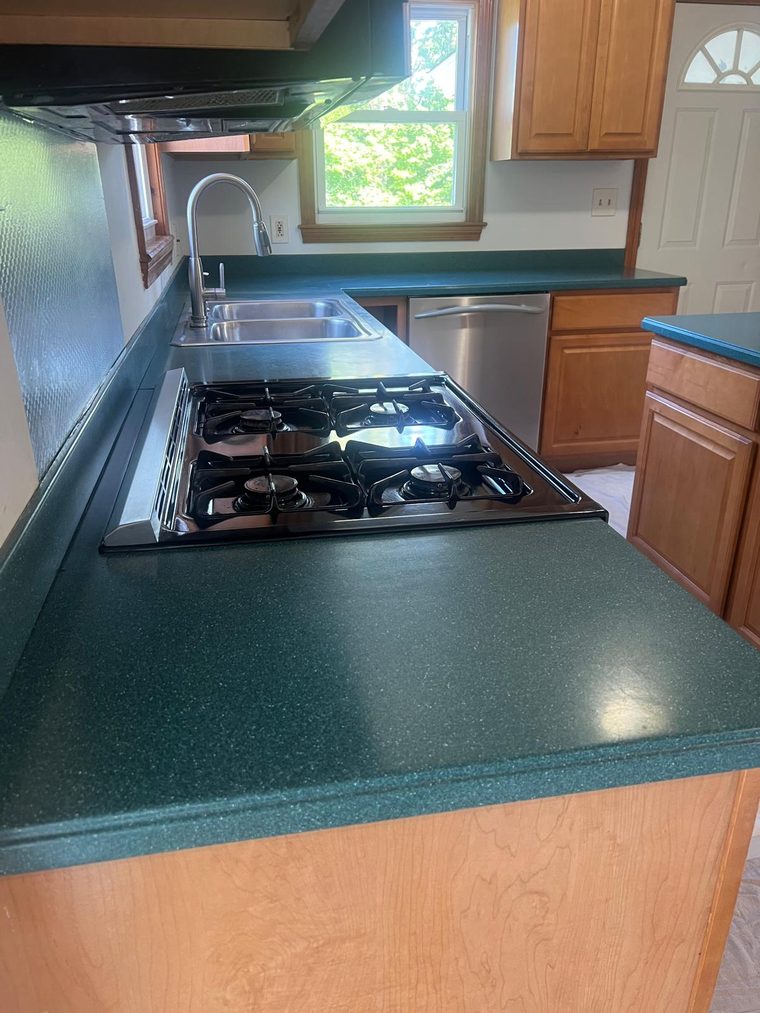 Dated dark green kitchen countertop before resurfacing