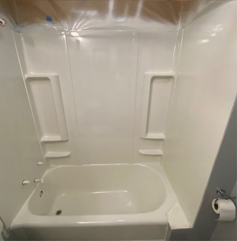 The same bathtub after refinishing, in a bright glossy white
