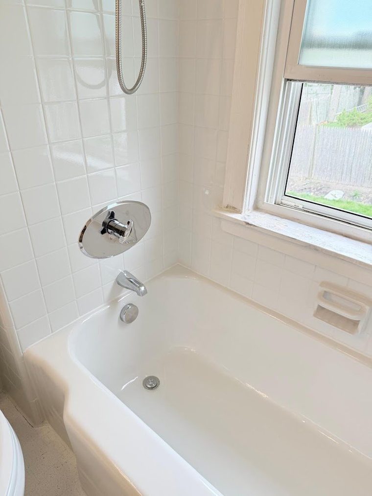 The same tub and tile after refinishing, in clean bright white